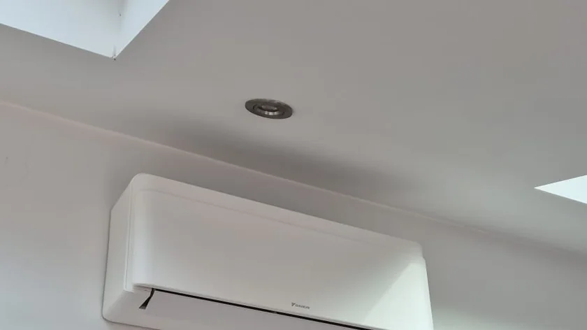 Wall-mounted air-to-air heat pump installed in a vaulted London loft room