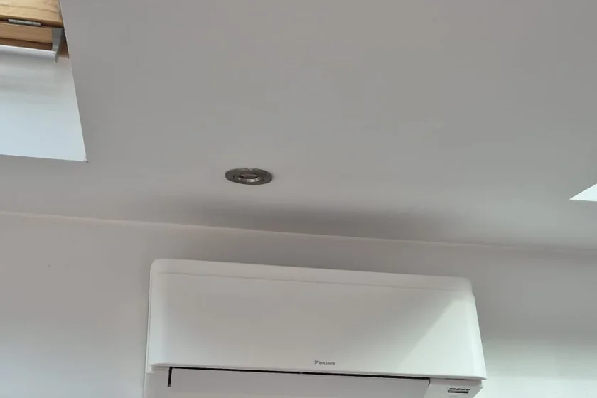 The finished wall-mounted air conditioning unit in the same loft conversion