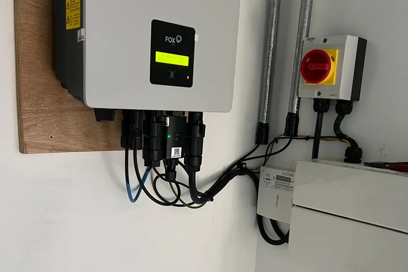 Fox ESS hybrid inverter and isolators fitted on a wall