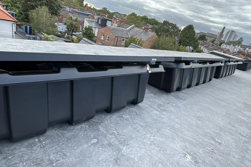 Ballast trays laid out on a flat roof before the panels go on