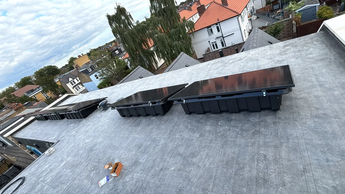 Solar panels on tilt frames on a London flat roof