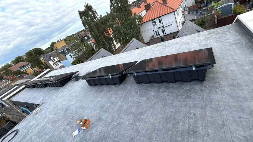 Solar panels on tilted frames on a London flat roof
