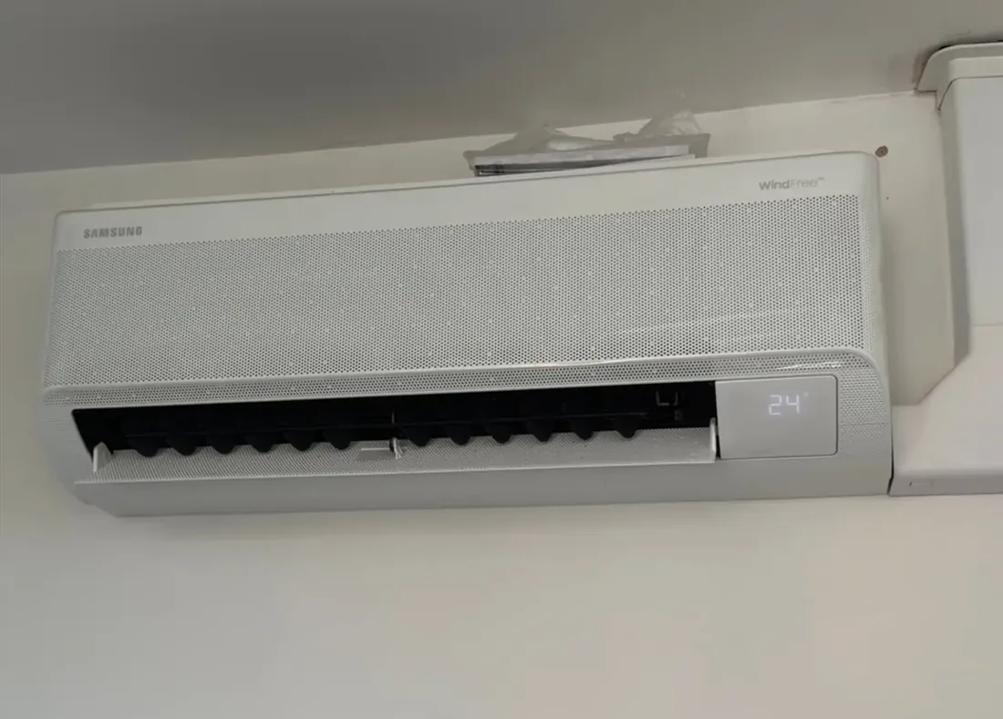 Wall mounted indoor unit with the filter cover open during a service